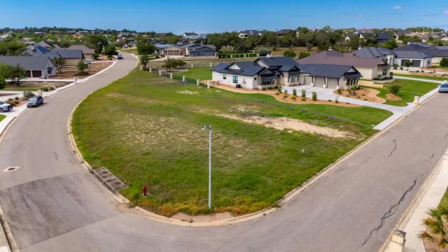 an aerial view of a house with a garden and houses