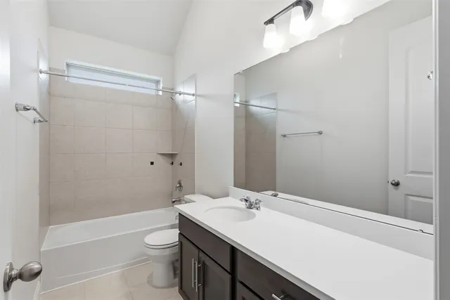 a view of empty room with wooden floor ceiling fan and kitchen view