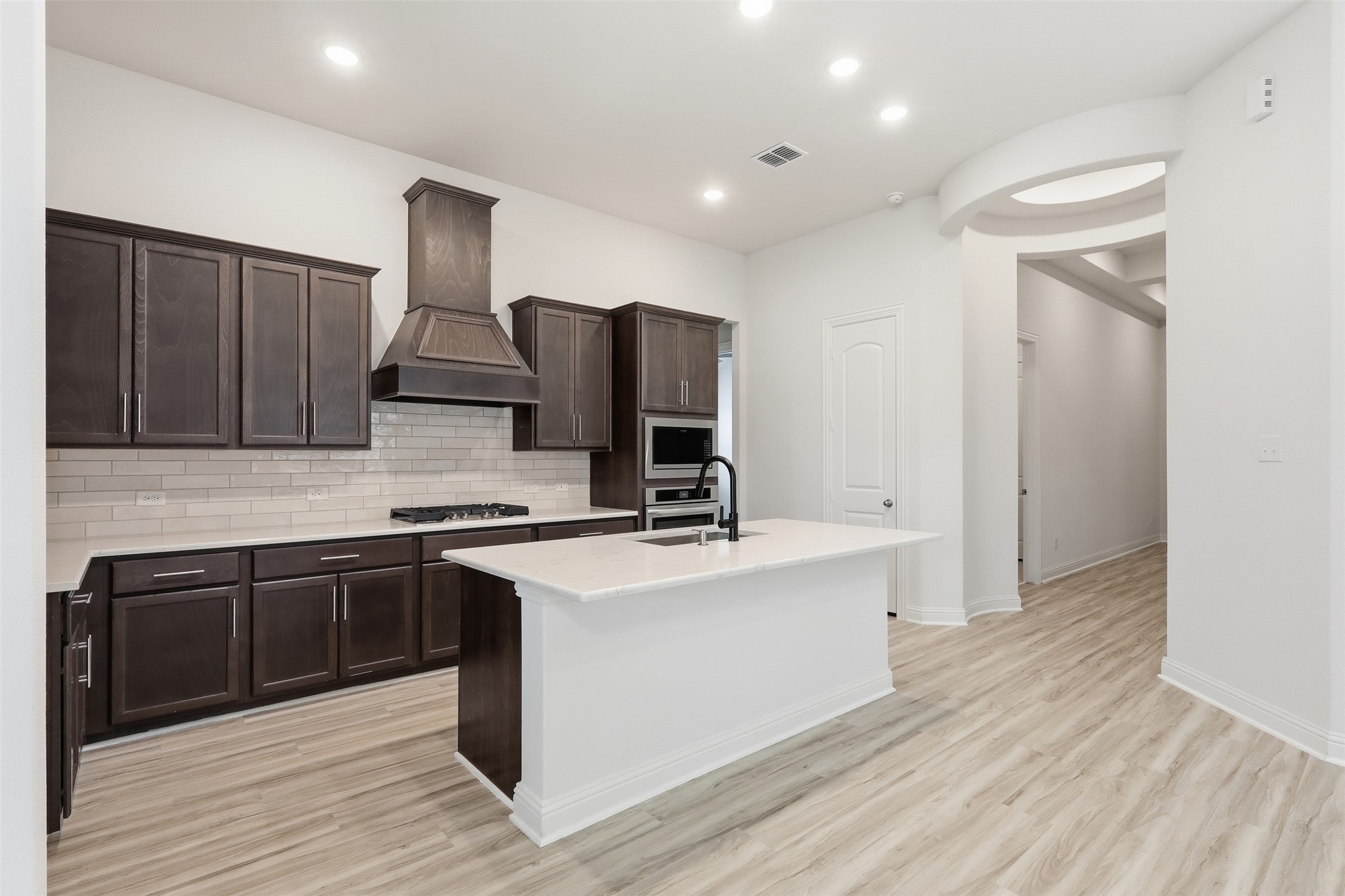 3006 Myrtle Bch Lane League City, TX 77573 - Photo 4 of 21 a kitchen with stainless steel appliances granite countertop a stove top oven a sink and a refrigerator