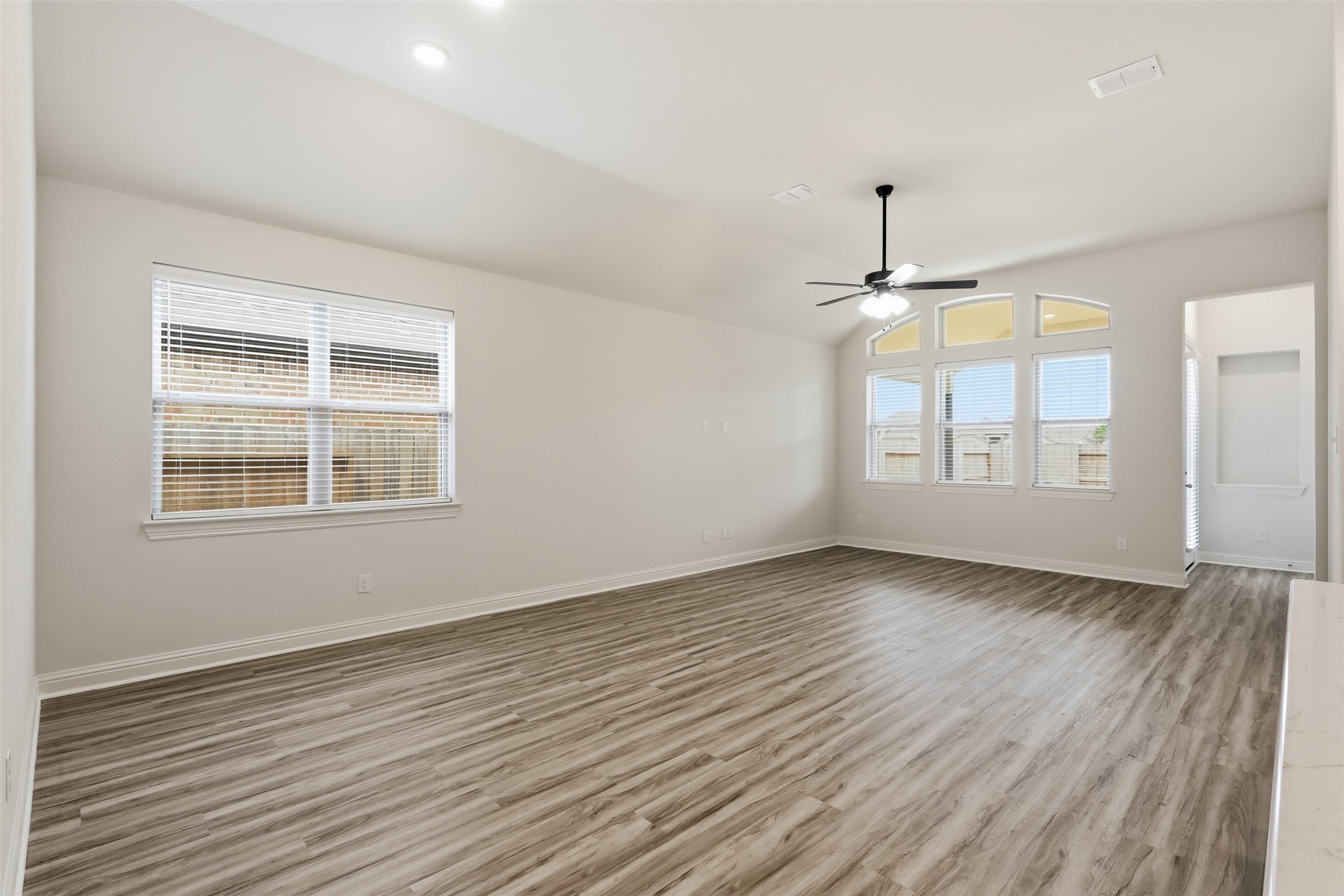 3006 Myrtle Bch Lane League City, TX 77573 - Photo 5 of 21 an empty room with wooden floor cabinet and windows