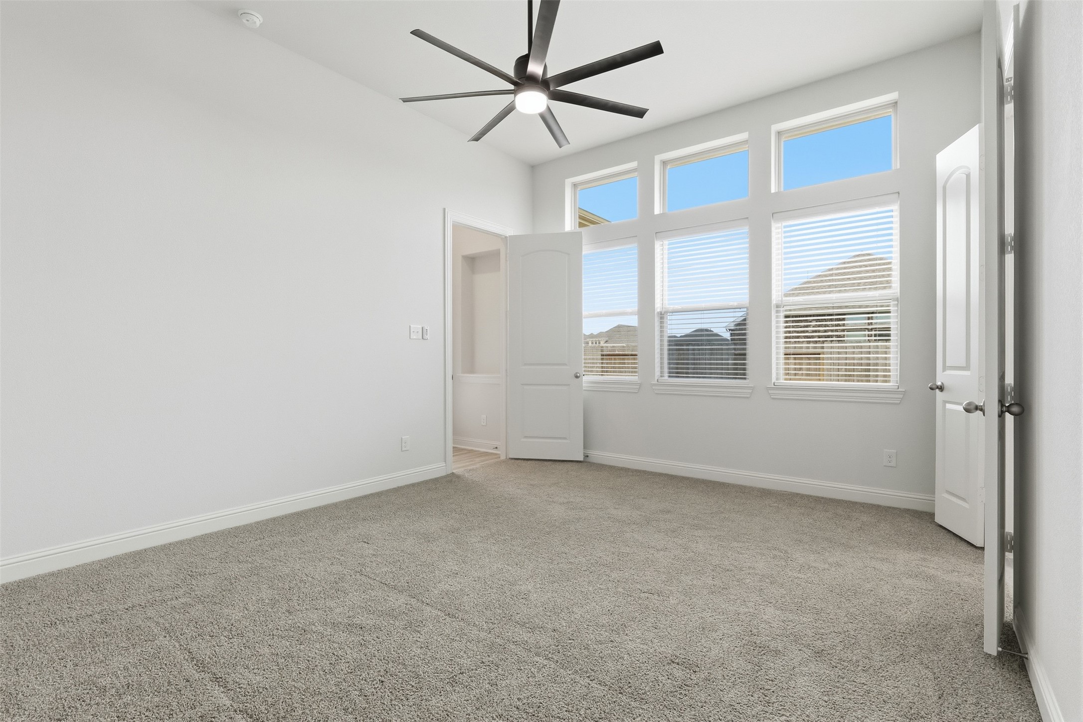 3006 Myrtle Bch Lane League City, TX 77573 - Photo 7 of 21 an empty room with chandelier fan and windows