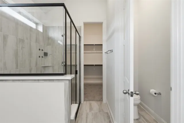 a bathroom with a toilet a sink and a mirror