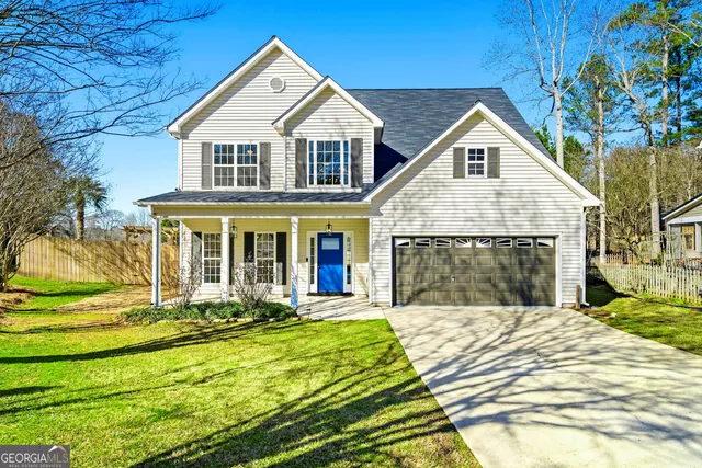 a front view of a house with a yard table and chairs
