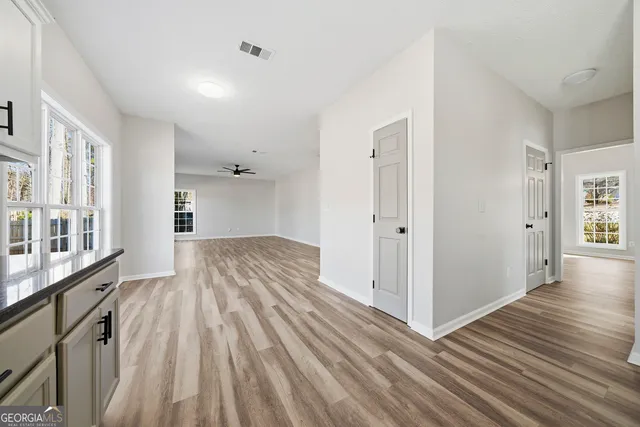 a view of empty room with wooden floor and fireplace