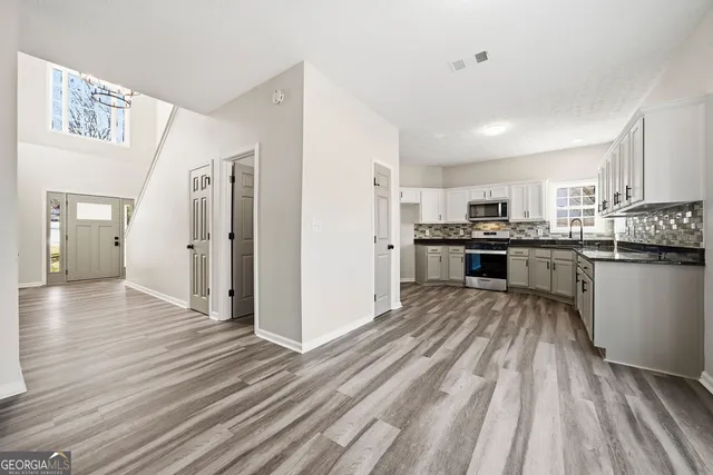 wooden floor in an empty room with a window