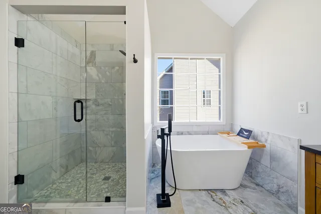 a bathroom with a granite countertop double vanity sink mirror and