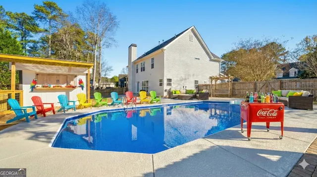 a swimming pool with outdoor seating