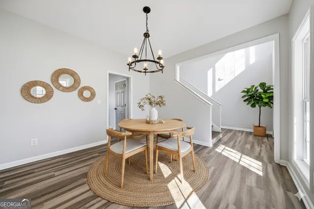 a view of a kitchen with wooden floor and electronic appliances