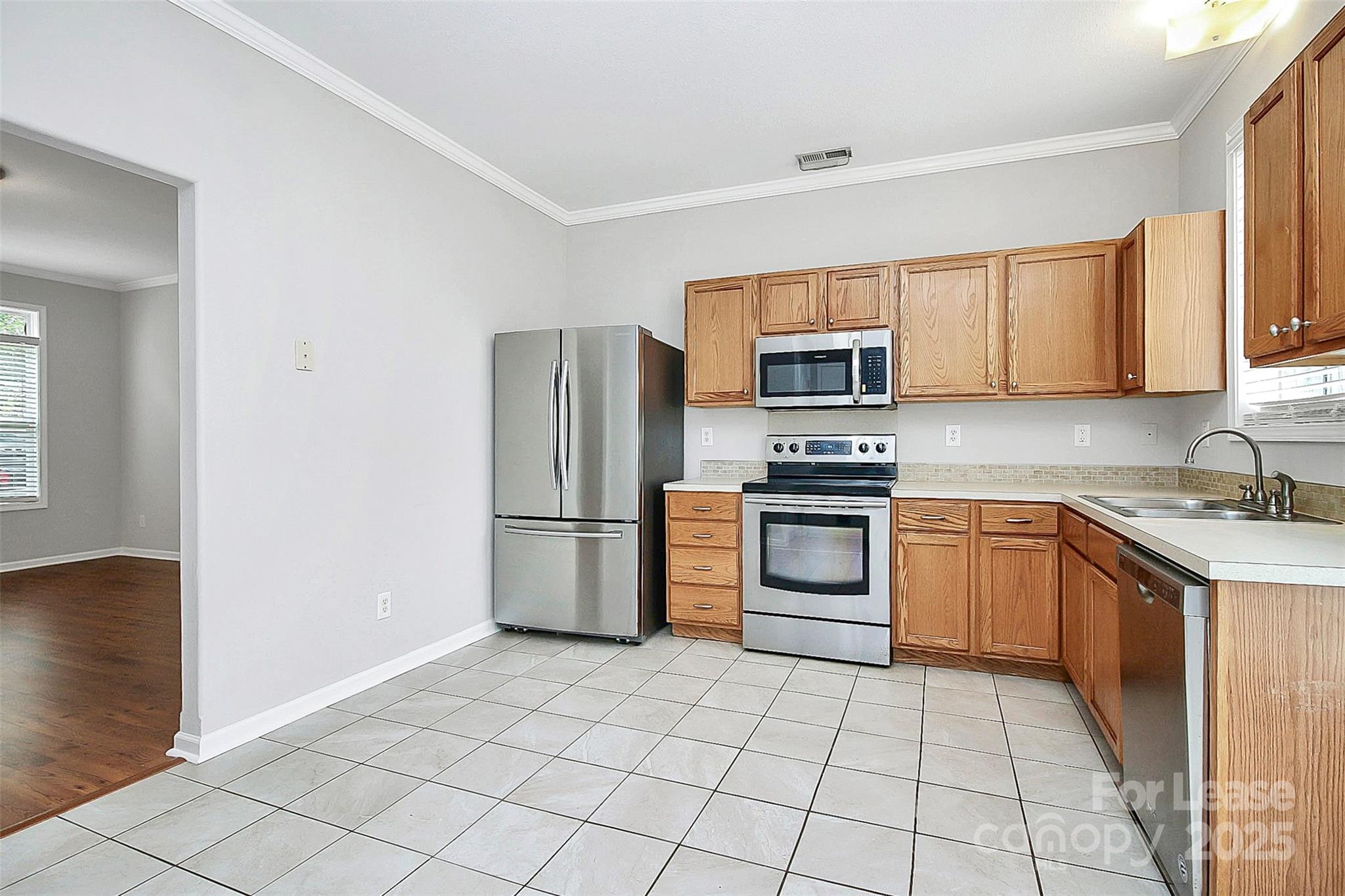 11263 Heritage Green Drive Cornelius, NC 28031 - Photo 11 of 32 a kitchen with a sink a microwave and refrigerator