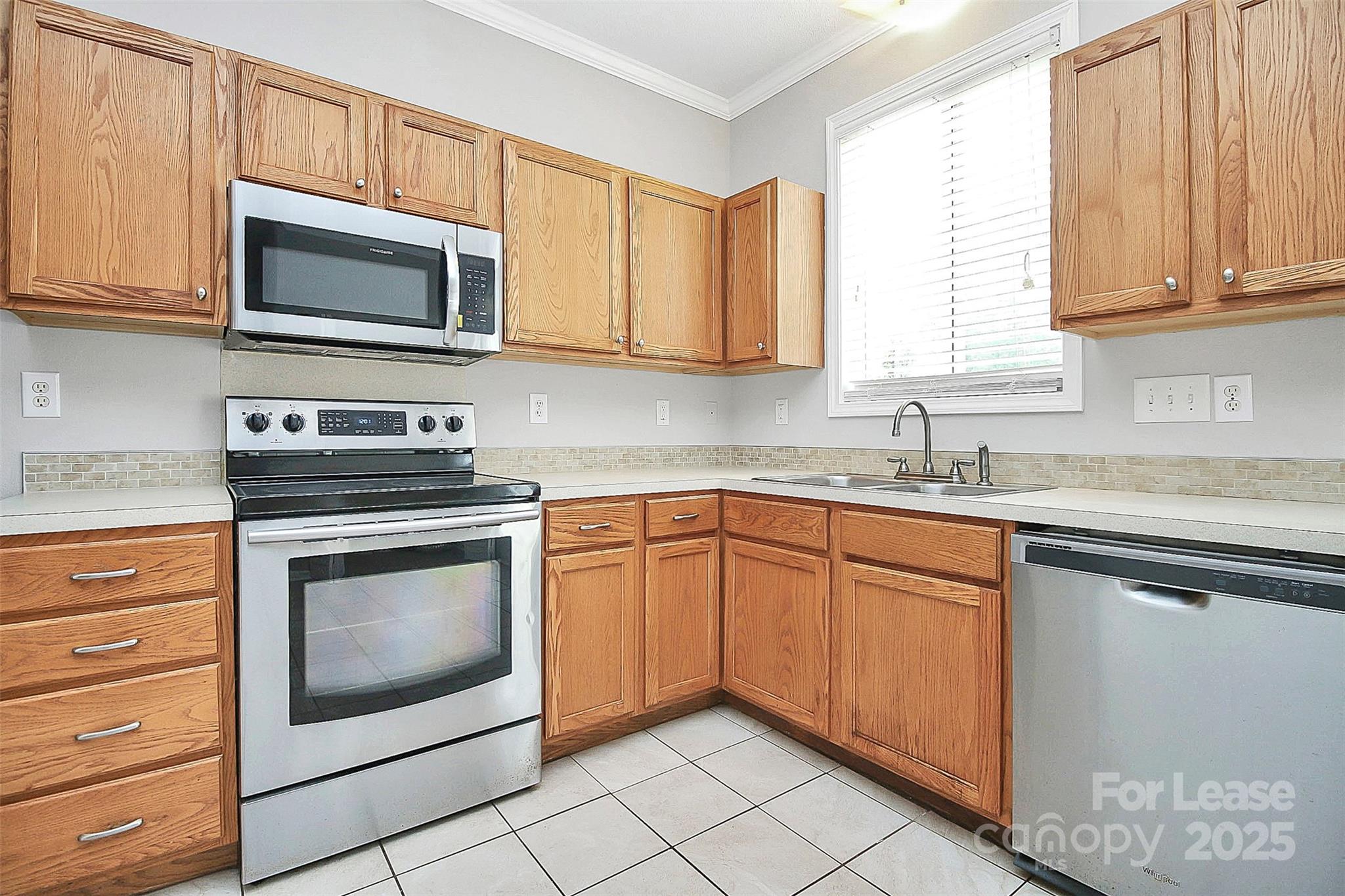 11263 Heritage Green Drive Cornelius, NC 28031 - Photo 12 of 32 a kitchen with granite countertop white cabinets stainless steel appliances and a sink