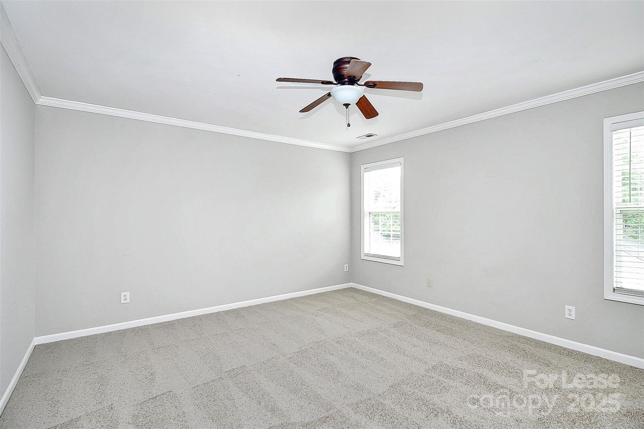 11263 Heritage Green Drive Cornelius, NC 28031 - Photo 17 of 32 an empty room with a window and a fan