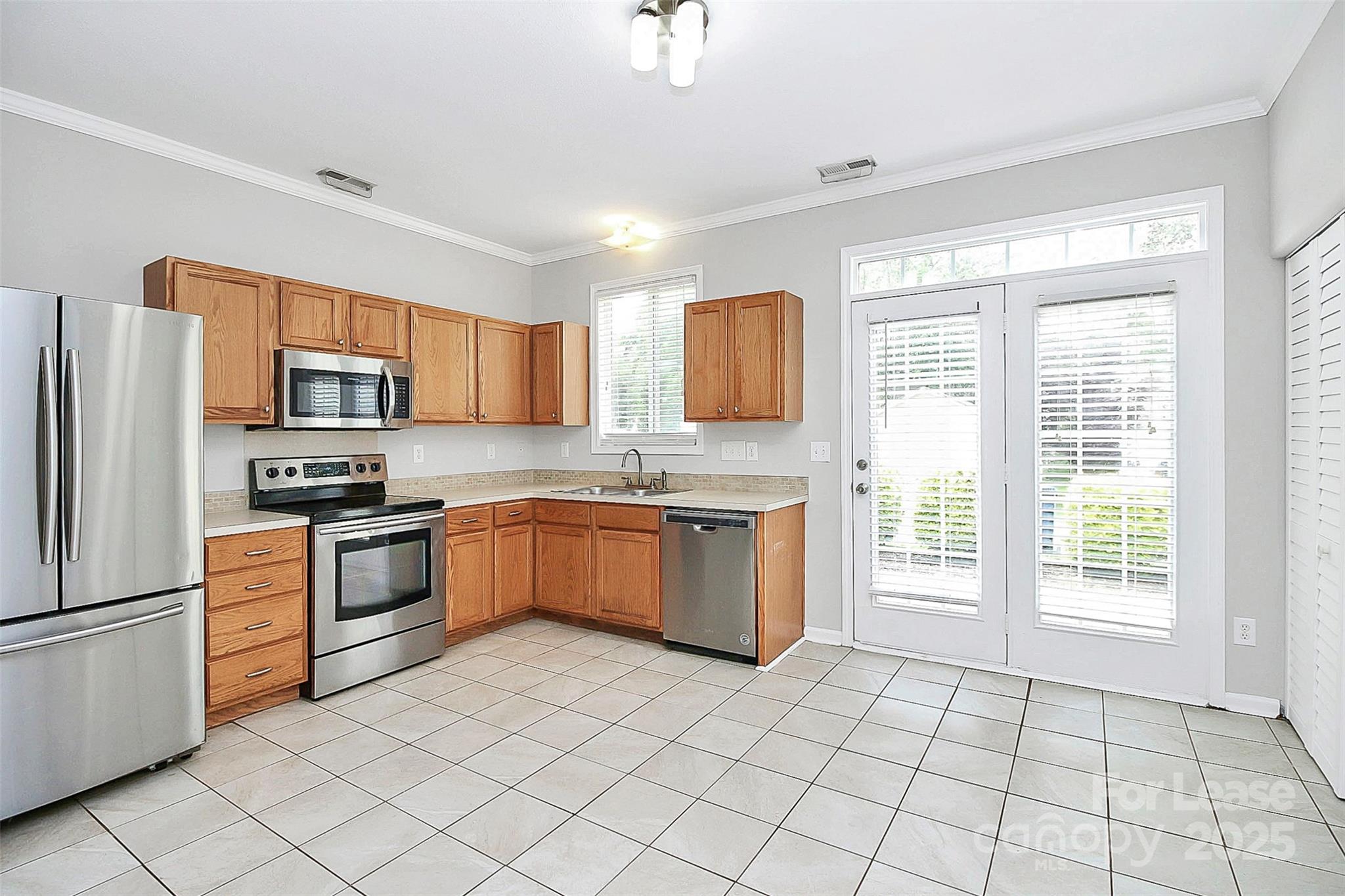 11263 Heritage Green Drive Cornelius, NC 28031 - Photo 9 of 32 a kitchen with stainless steel appliances granite countertop a refrigerator sink and stove