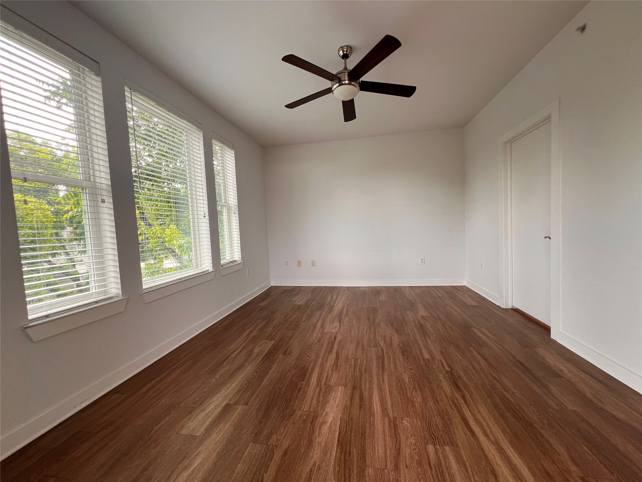 1900 Barton Springs Road, Unit 4041 Austin, TX 78704 - Photo 6 of 35 a view of empty room with wooden floor and fan