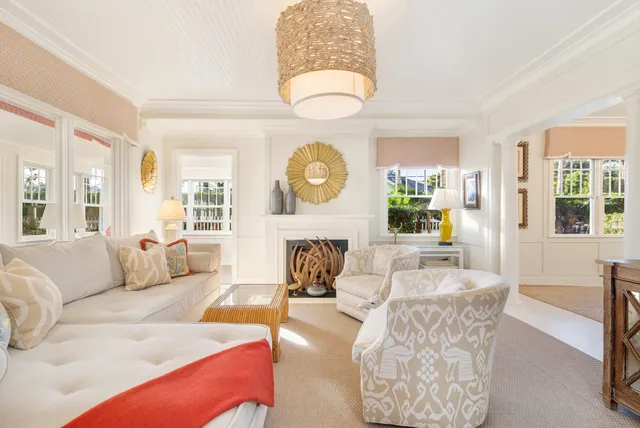 a living room with furniture a fireplace and a large window