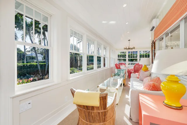 a view of a dining room with furniture a livingroom and chandelier