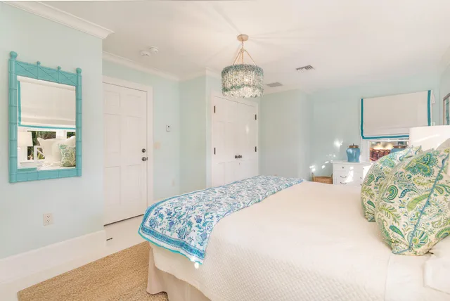 a bedroom with a bed and a chandelier