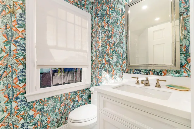 a bathroom with a sink a toilet and a mirror