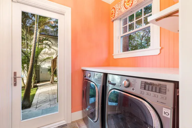 a utility room with mirror and furniture