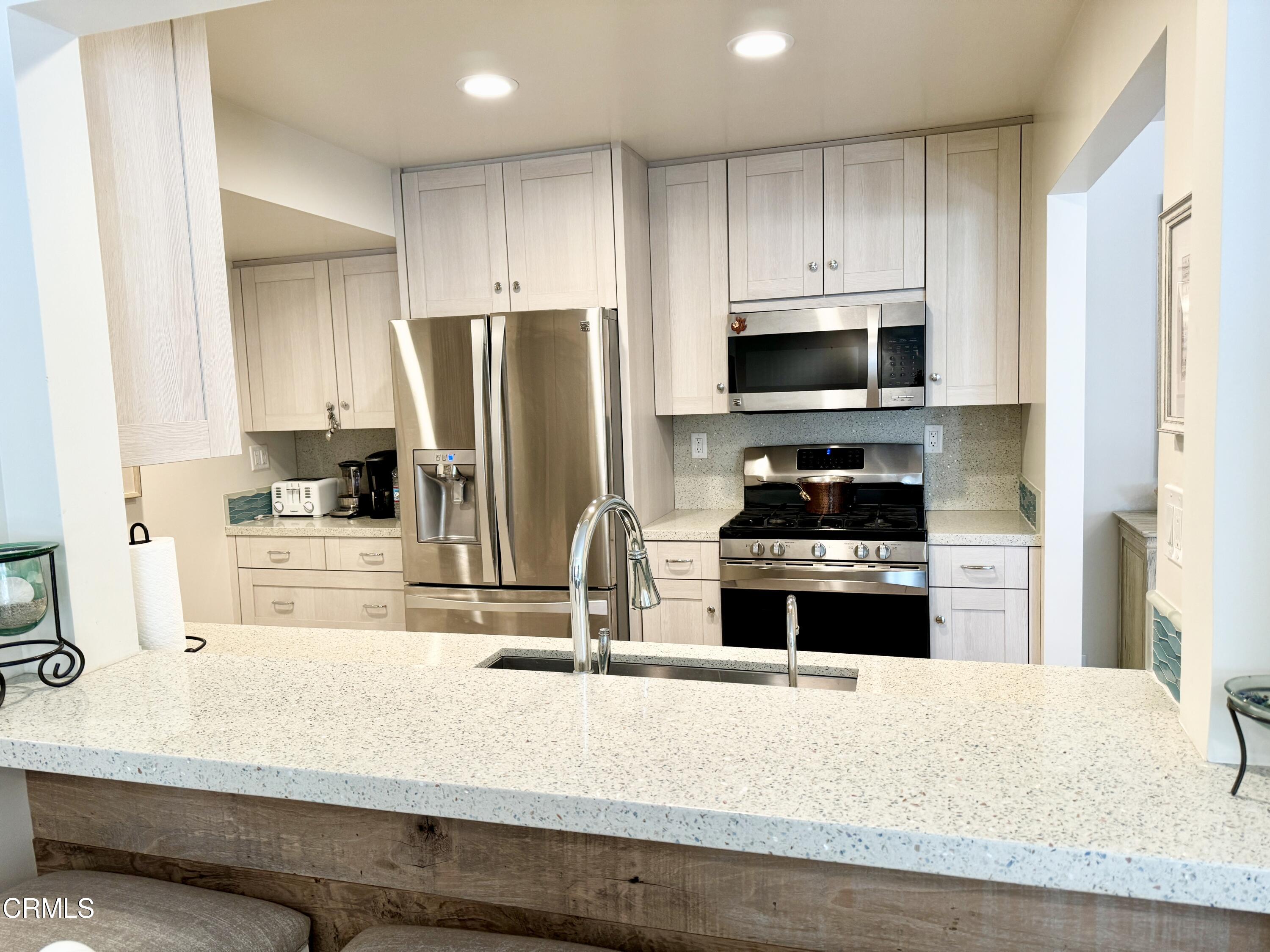 1915 Majorca Drive Oxnard, CA 93035 - Photo 9 of 29 a kitchen with granite countertop a refrigerator and a stove top oven