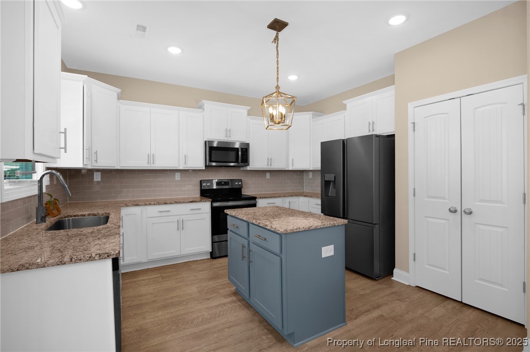 405 Shelton Beard Road Stedman, NC 28391 - Photo 12 of 36 a kitchen with stainless steel appliances granite countertop a refrigerator stove a sink and microwave