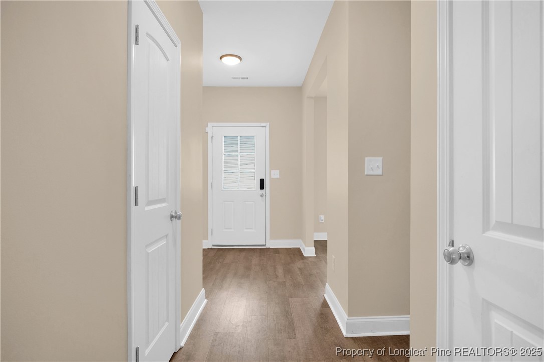 405 Shelton Beard Road Stedman, NC 28391 - Photo 17 of 36 a view of a hallway with wooden floor