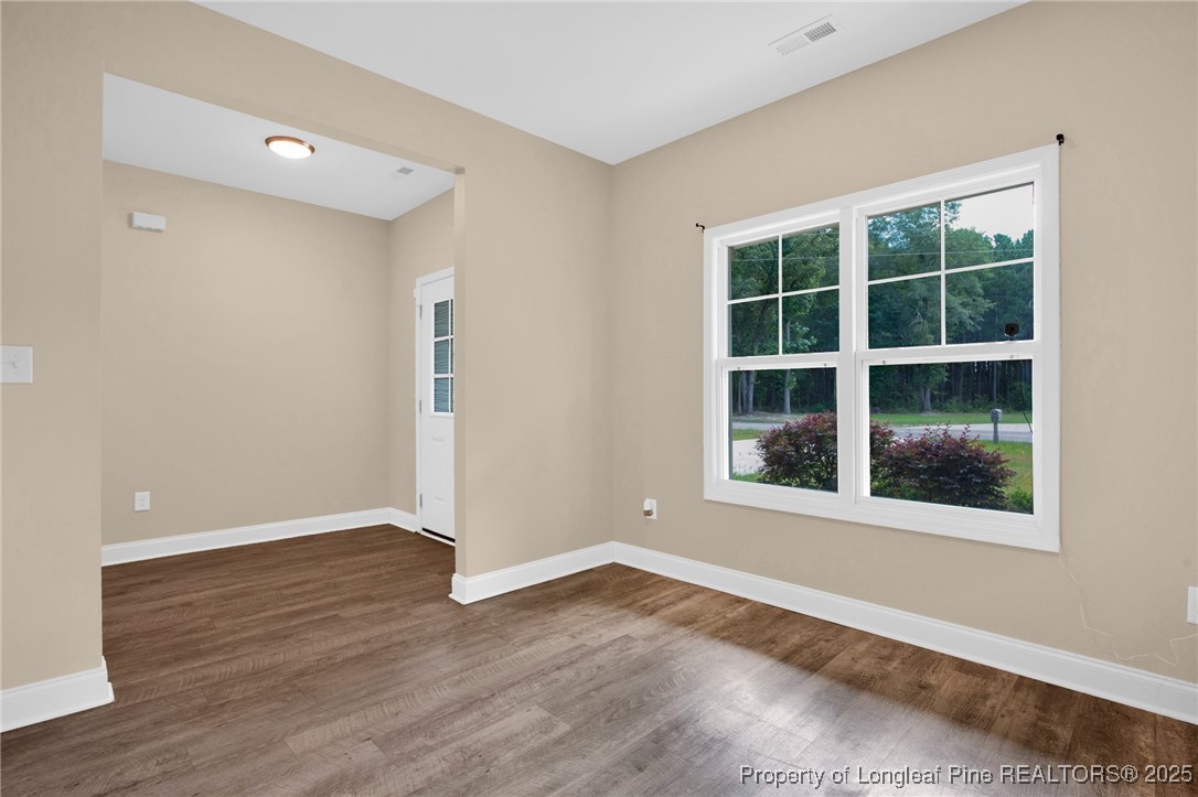 405 Shelton Beard Road Stedman, NC 28391 - Photo 18 of 36 a view of an empty room with wooden floor and windows