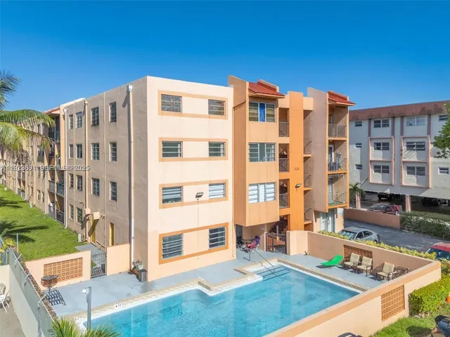 a view of pool with a yard