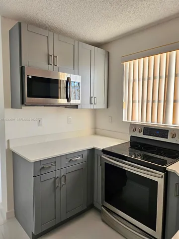 a kitchen with cabinets appliances and a sink
