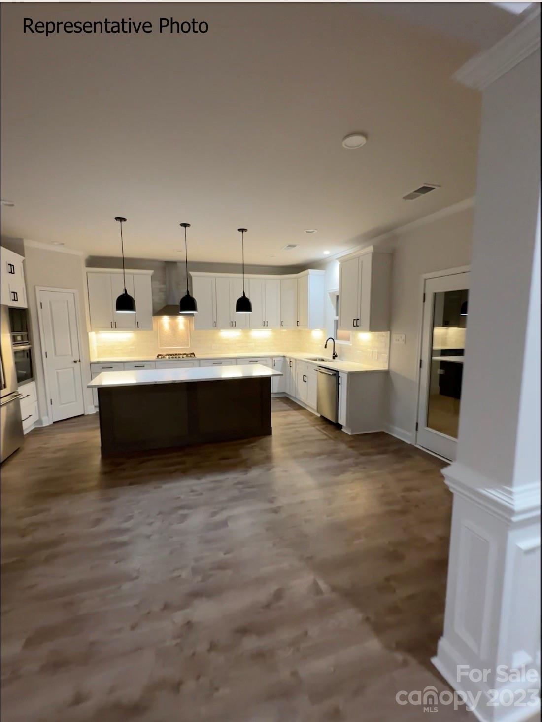 2432 Lakeview Circle Matthews, NC 28105 - Photo 18 of 20 a view with kitchen island a sink a stove and a refrigerator