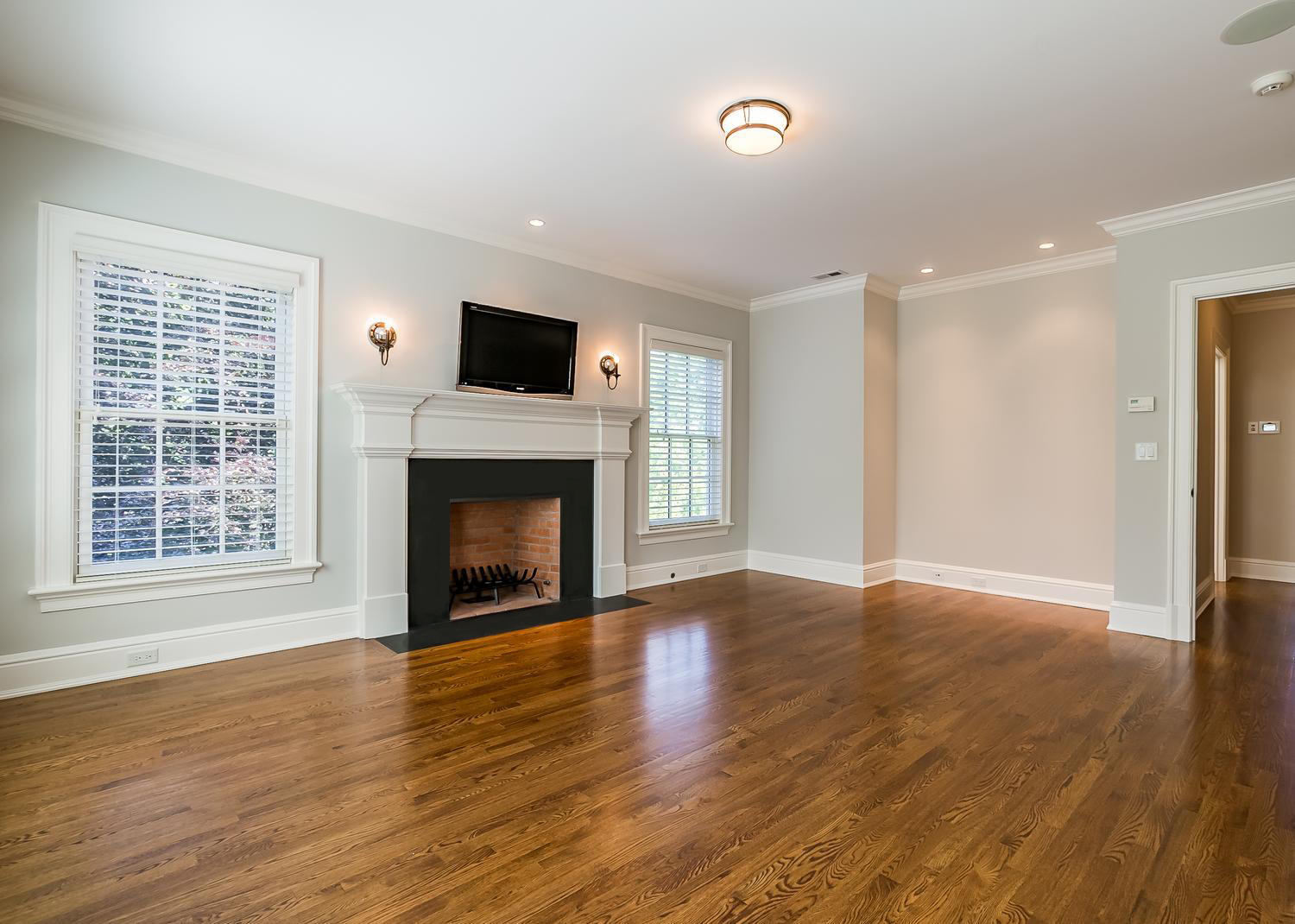 92 White Oak Shade Road New Canaan, CT 06840 - Photo 18 of 35 a view of an empty room with wooden floor fireplace and a window