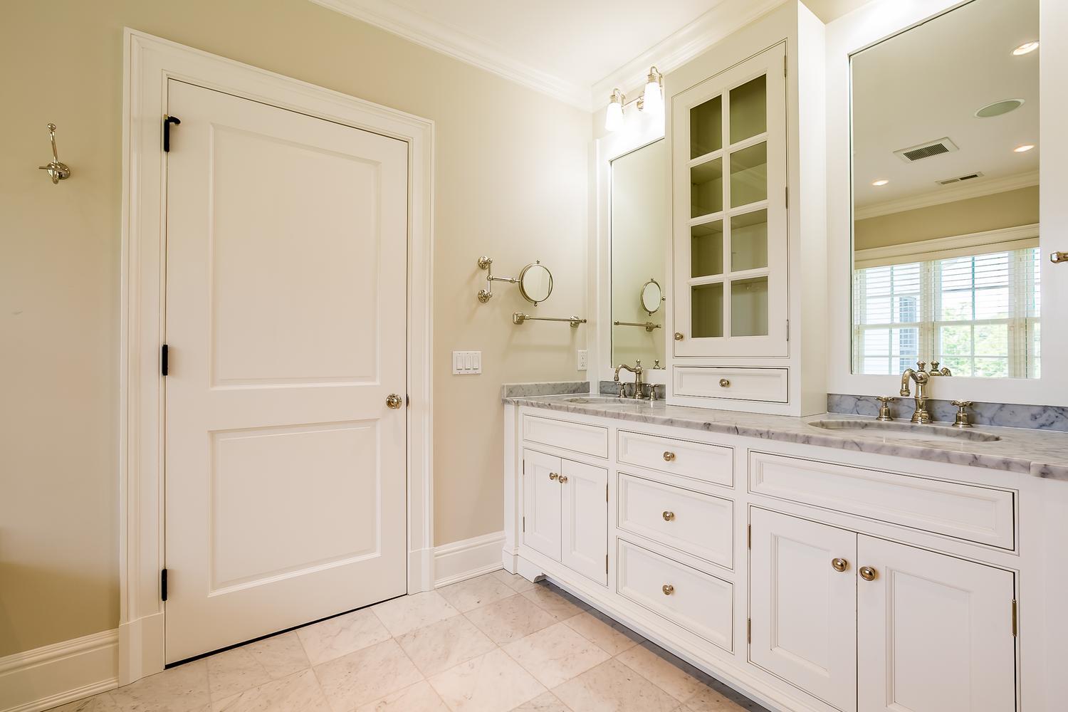 92 White Oak Shade Road New Canaan, CT 06840 - Photo 19 of 35 a bathroom with a granite countertop sink two mirror and a window
