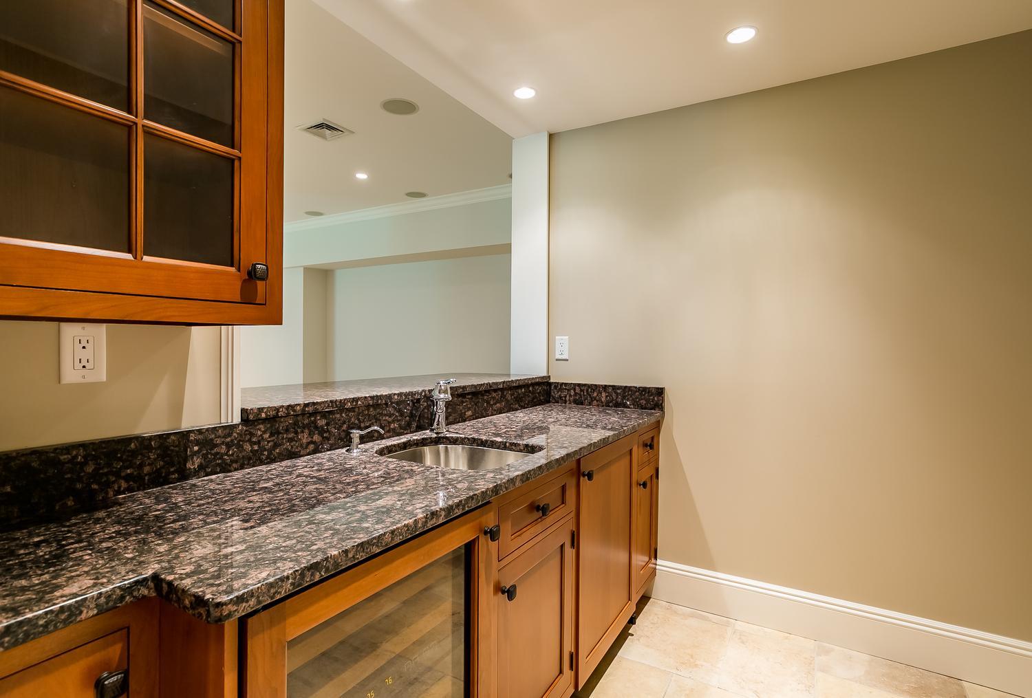 92 White Oak Shade Road New Canaan, CT 06840 - Photo 30 of 35 a bathroom with a granite countertop sink and a mirror