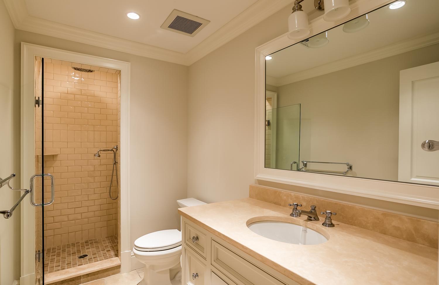 92 White Oak Shade Road New Canaan, CT 06840 - Photo 31 of 35 a bathroom with a granite countertop sink a toilet a mirror and shower