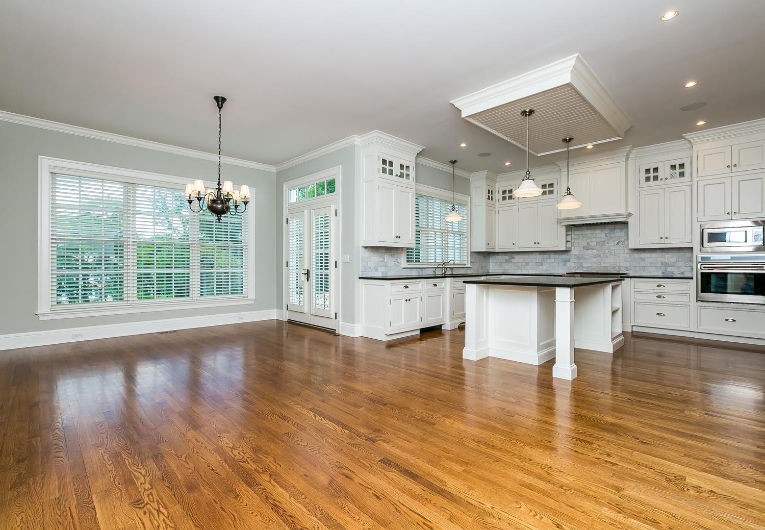 92 White Oak Shade Road New Canaan, CT 06840 - Photo 9 of 35 a large kitchen with stainless steel appliances kitchen island granite countertop a stove a refrigerator a sink dishwasher and white cabinets with wooden floor
