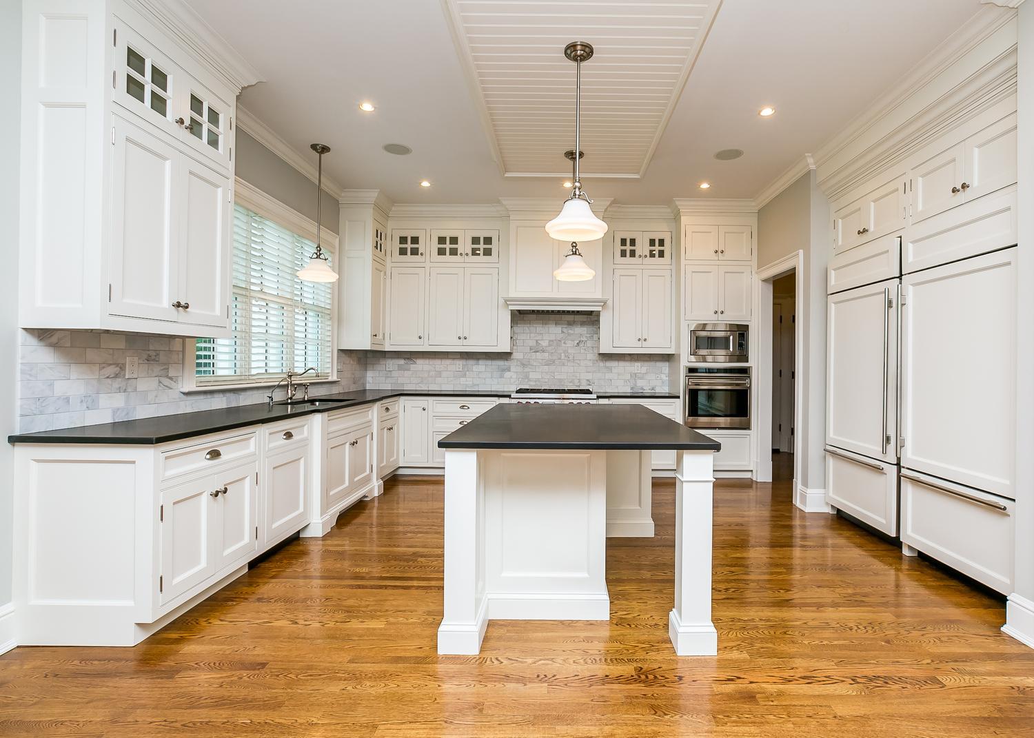 92 White Oak Shade Road New Canaan, CT 06840 - Photo 10 of 35 a large kitchen with stainless steel appliances kitchen island granite countertop a stove a sink a refrigerator and white cabinets with wooden floor