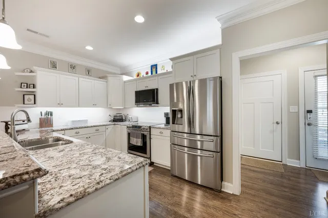 a kitchen with granite countertop a sink and cabinets