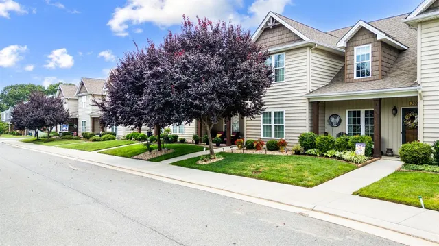 a front view of house with yard and green space