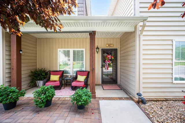 a view of a house with sitting area and potted plants