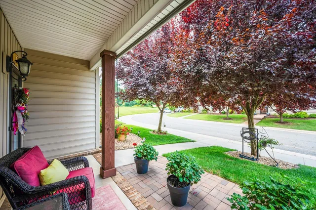 a view of a porch with furniture and a yard