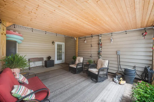 a balcony with furniture and a potted plant