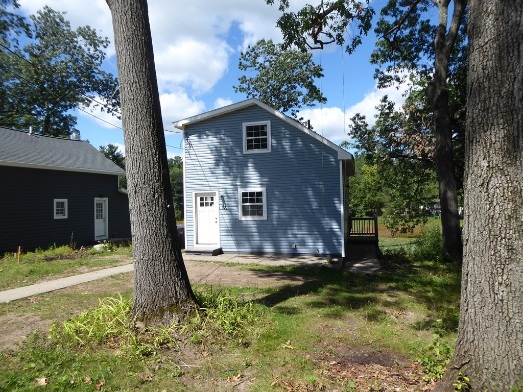 86 Pequot Point Road Westfield, MA 01085 - Photo 1 of 21 a house with green field in front of it