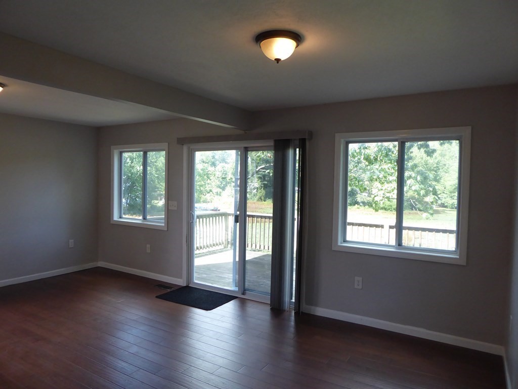86 Pequot Point Road Westfield, MA 01085 - Photo 3 of 21 an empty room with wooden floor and windows