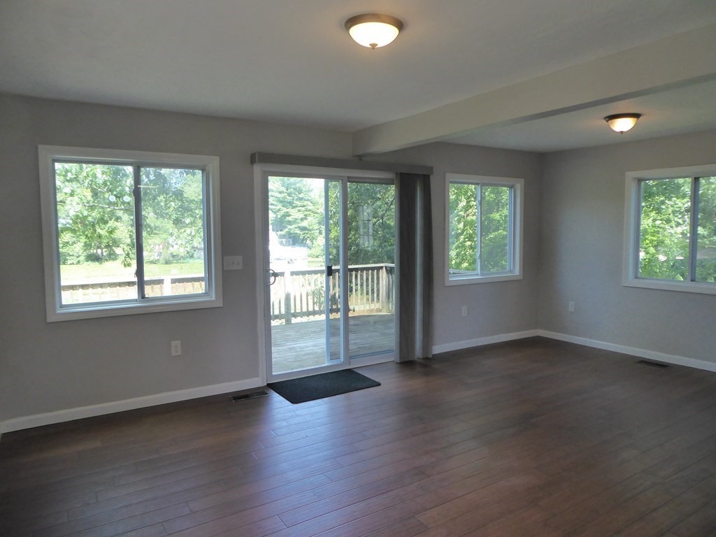 86 Pequot Point Road Westfield, MA 01085 - Photo 4 of 21 a view of an empty room with wooden floor and a window
