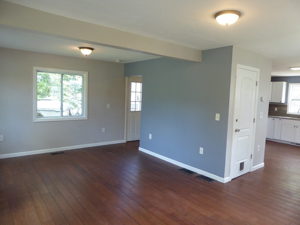 86 Pequot Point Road Westfield, MA 01085 - Photo 5 of 21 a view of an empty room with wooden floor and a window