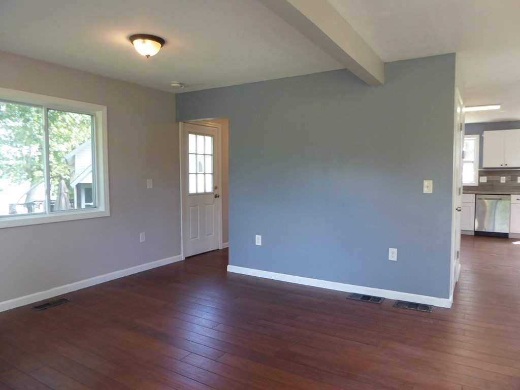 86 Pequot Point Road Westfield, MA 01085 - Photo 6 of 21 a view of an empty room with wooden floor and a window