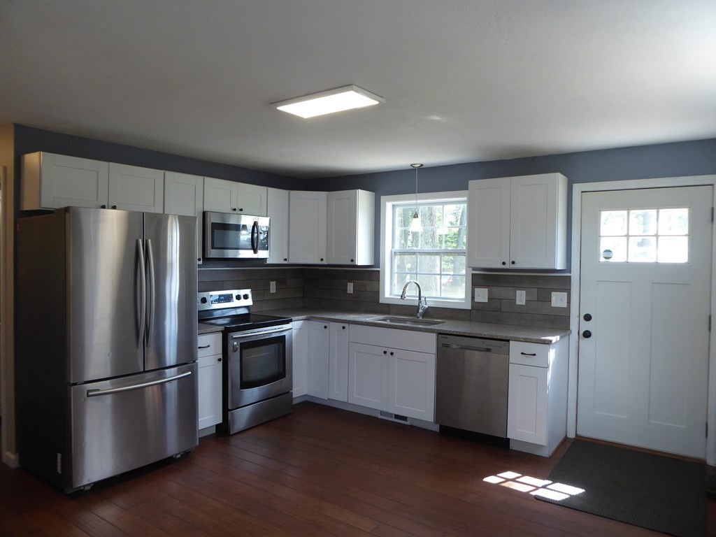 86 Pequot Point Road Westfield, MA 01085 - Photo 7 of 21 a kitchen with stainless steel appliances granite countertop a refrigerator a stove a sink and a microwave