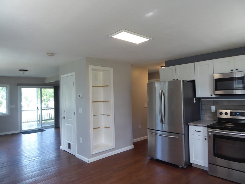 86 Pequot Point Road Westfield, MA 01085 - Photo 8 of 21 a kitchen with stainless steel appliances a refrigerator and a stove top oven