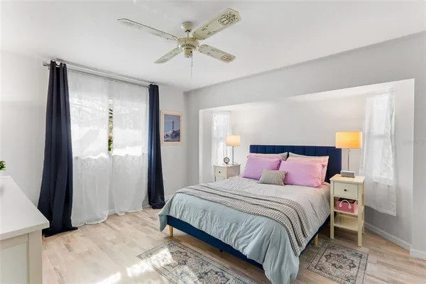 a bedroom with a bed and a chandelier