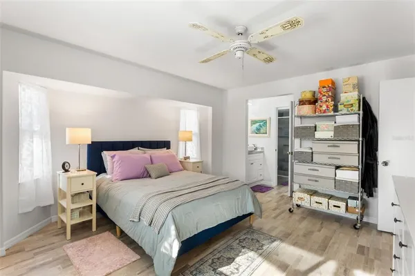 a bedroom with a bed and a chandelier