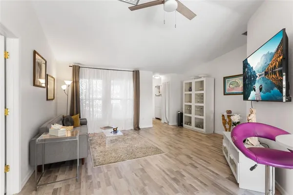 a living room with furniture and wooden floor